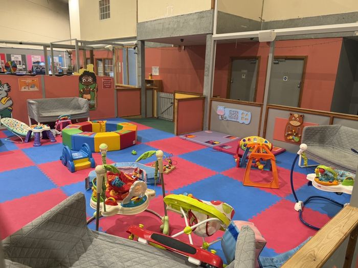 Baby soft play area with toys, walkers and seating