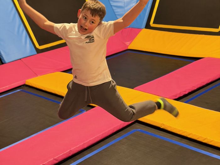 Child jumping on the trampoline area
