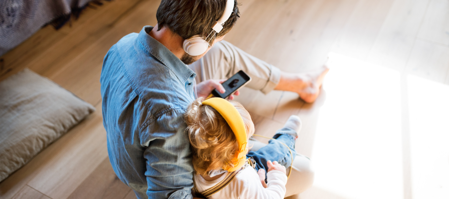 man and child listening to podcasts